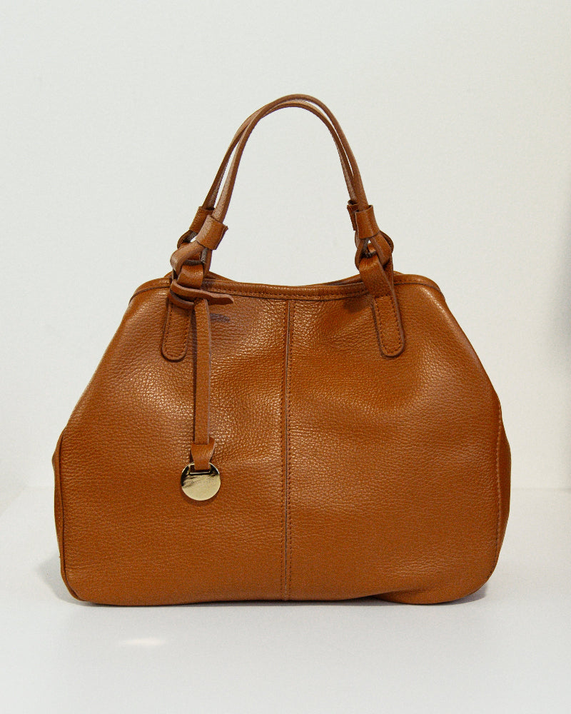 Brown leather handbag with a gold clasp on a light gray background