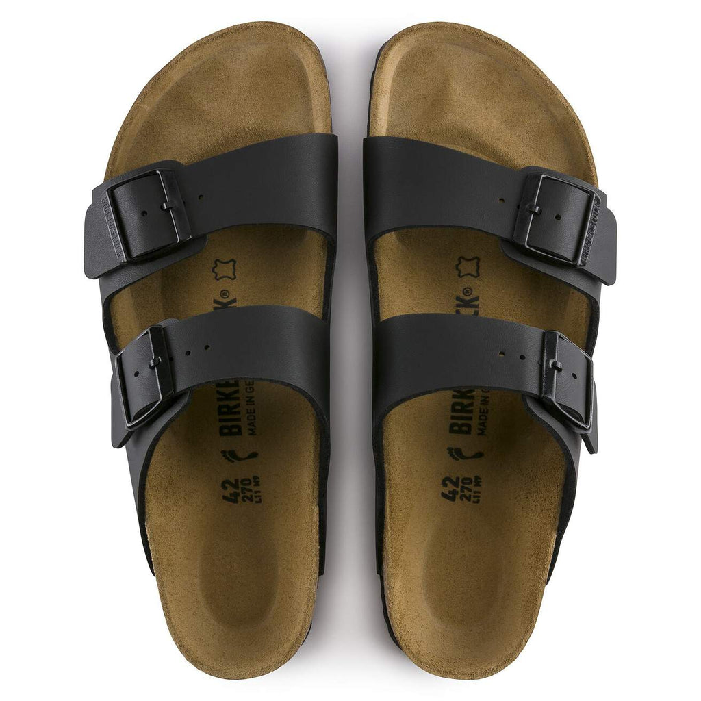 Pair of brown sandals with black straps on a white background