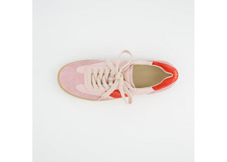 Pink and red sneaker on a light gray background