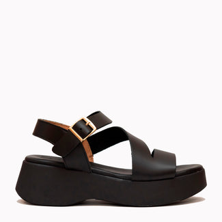 Black sandal with a platform sole on a white background