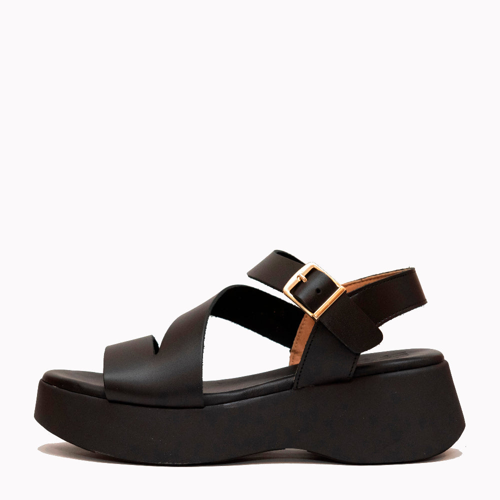 Black sandal with a platform sole on a white background