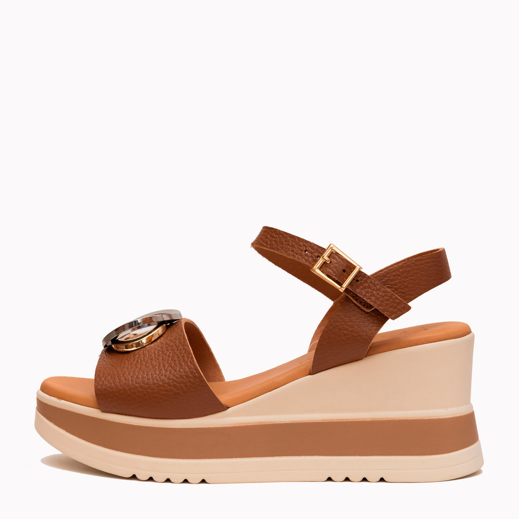 Brown wedge sandal with a beige sole on a white background