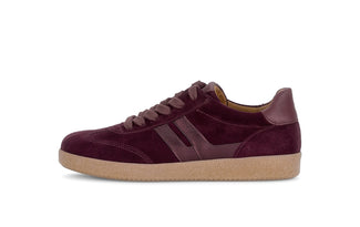 Maroon sneaker with a brown sole on a white background