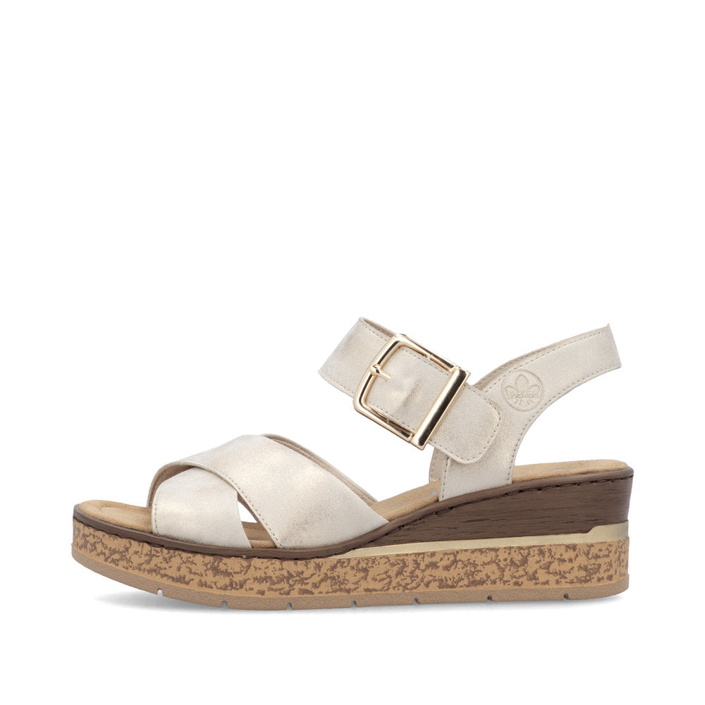 White wedge sandal with a brown sole on a white background