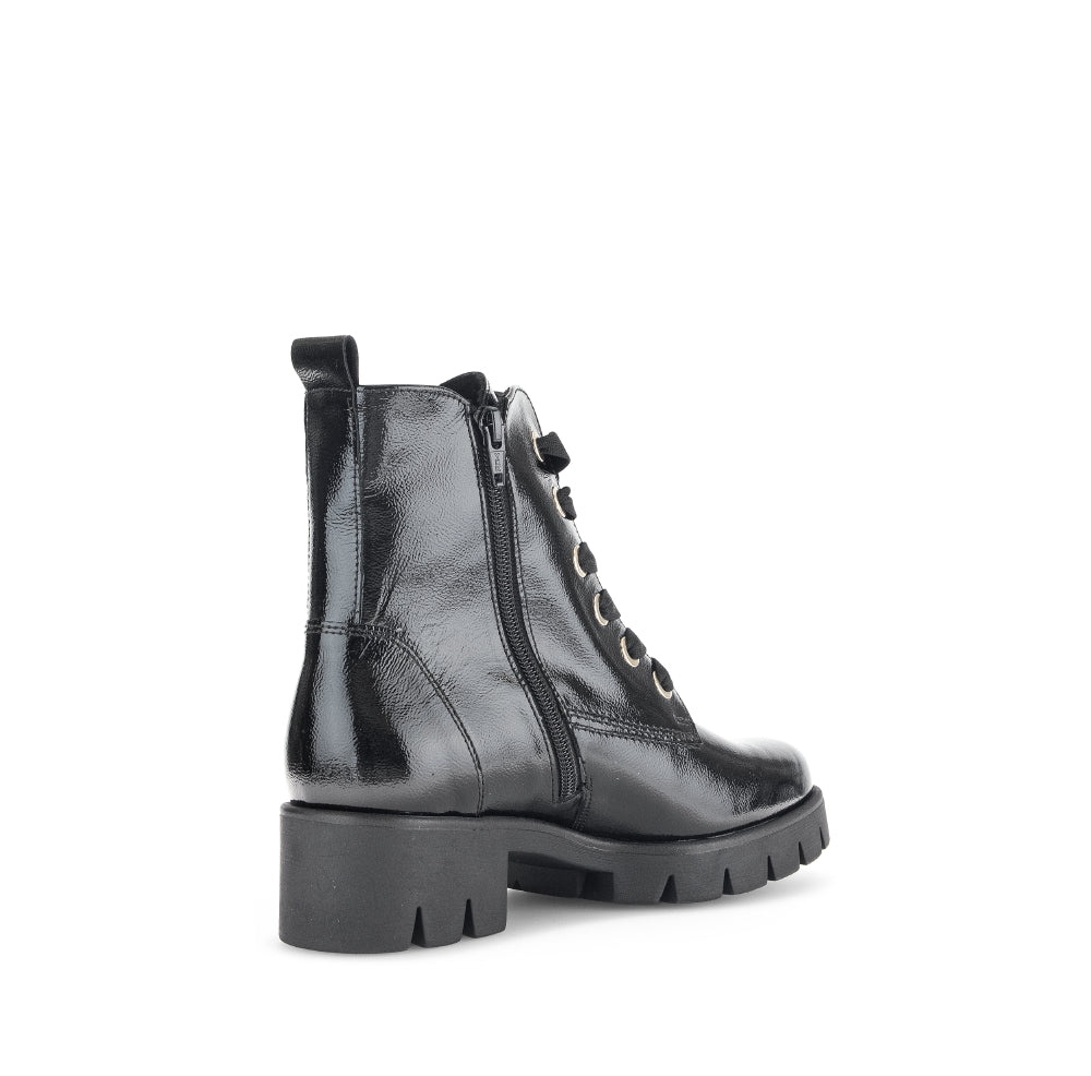 Black leather boot with a zipper on a white background