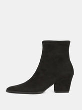 Load image into Gallery viewer, A single black suede ankle boot with a low block heel and pointed toe, shown in profile against a light gray background.
