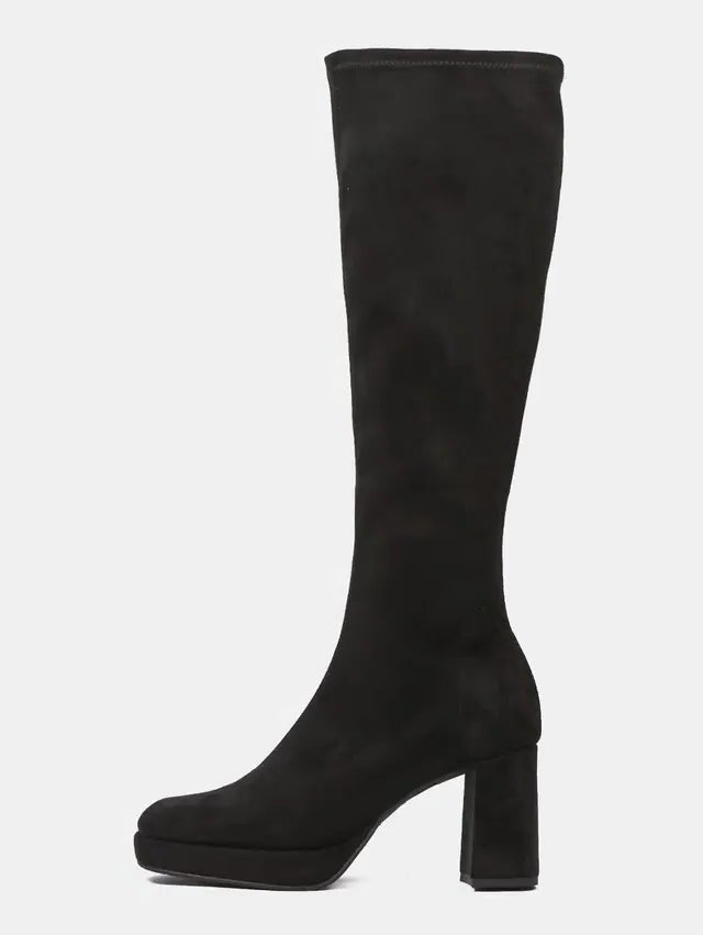A single black suede knee-high boot with a chunky block heel and rounded toe, shown in profile against a light gray background.
