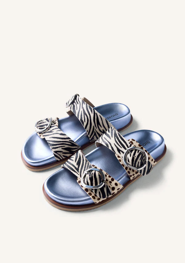 Blue sandals with zebra pattern straps on a white background