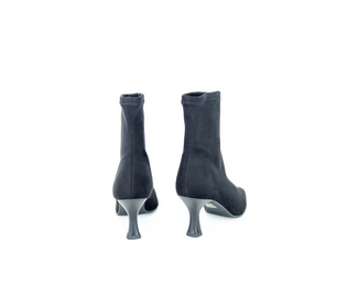 Black sock boot with a thin heel on a white background