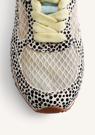 Pair of animal print sneakers with light-colored accents on a white background