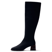 Load image into Gallery viewer, A single black knee-high ribbed boot with a pointed toe and a textured block heel, shown in profile against a solid white background.
