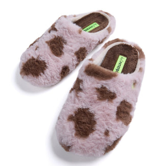 A single fluffy slip-on mule slipper in pale pink with irregular brown patches, shown in side profile on a clean white background.