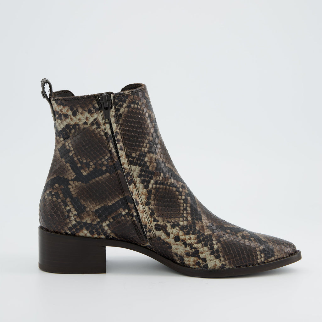 Snake print ankle boot on a light gray background