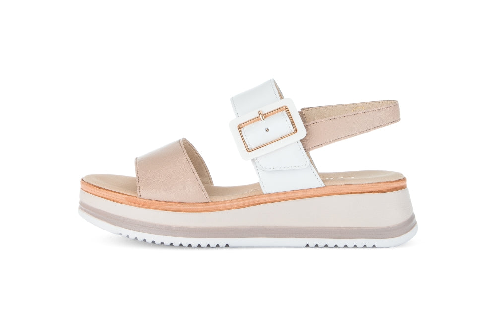 Beige and white sandal with a platform sole on a white background