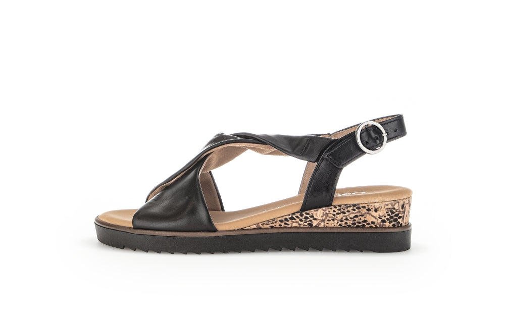 Black sandal with a leopard print sole on a white background
