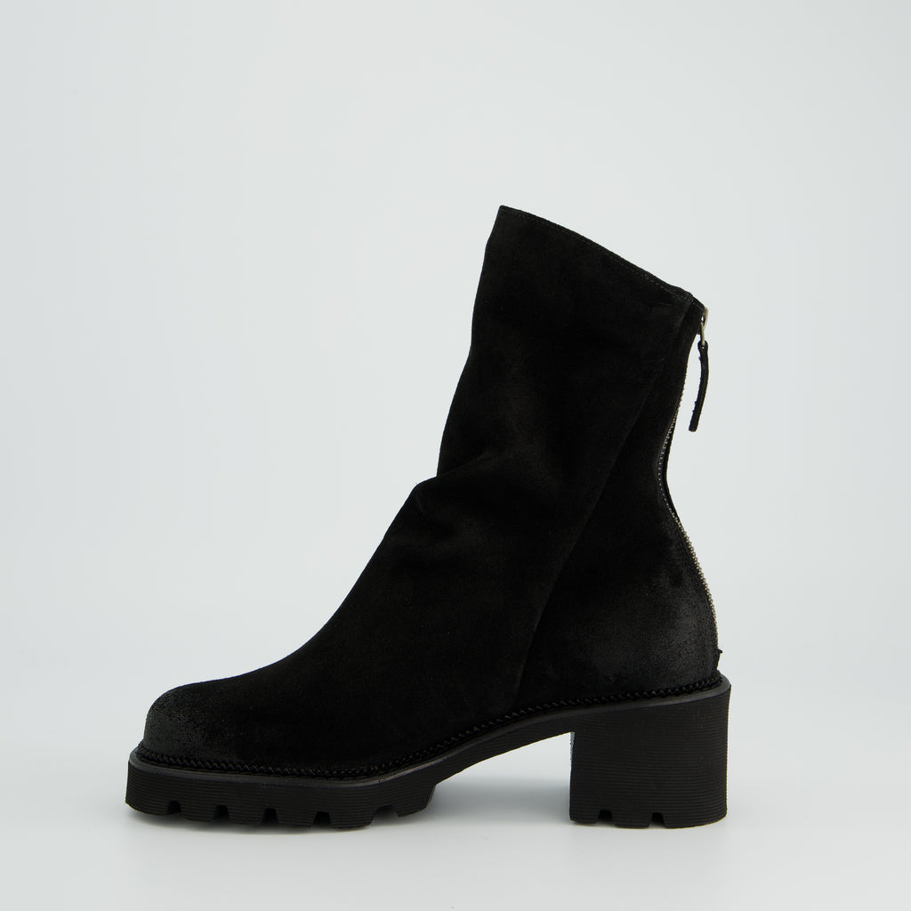 Black ankle boot on a light gray background