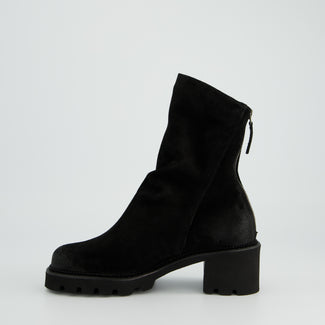 Black ankle boot on a light gray background