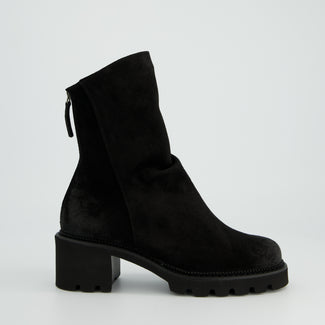 Black ankle boot on a light gray background