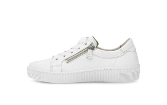 White sneaker with a gold zipper on a white background