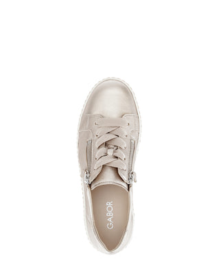 gold sneaker with a platform sole on a white background