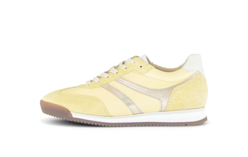 Yellow sneaker with white sole on a white background