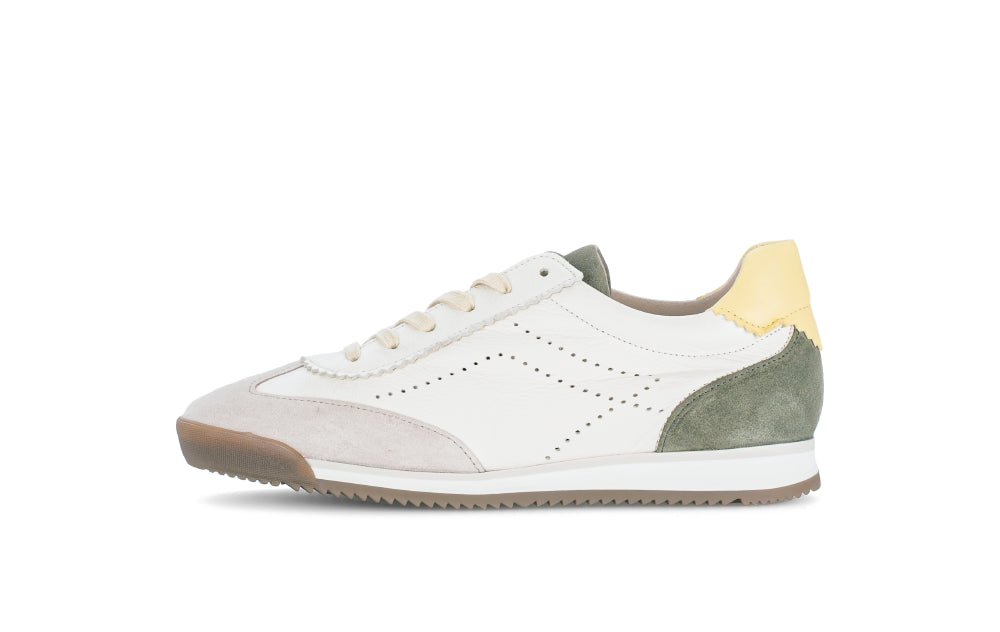 White sneaker with green and yellow accents on a white background