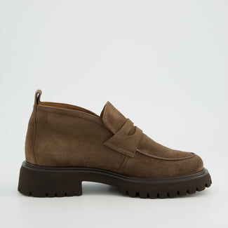 Brown suede loafer shoe on a light gray background