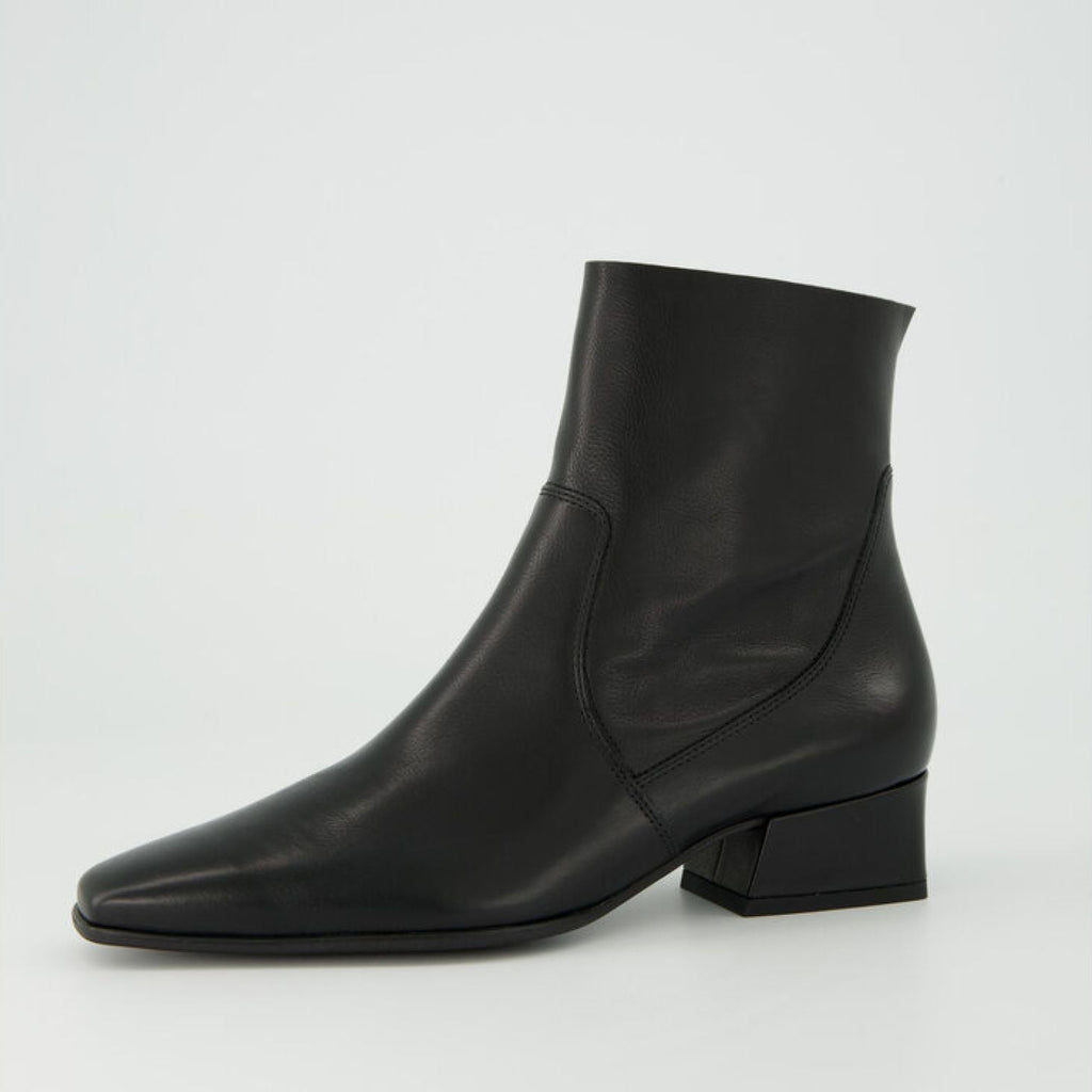 Black ankle boot on a light gray background
