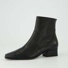 Load image into Gallery viewer, Black ankle boot on a light gray background
