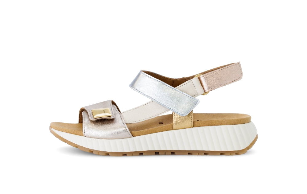 White sandal with beige sole on a white background