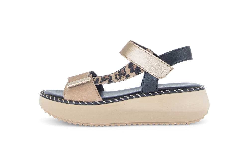 Beige sandal with leopard print strap on a white background