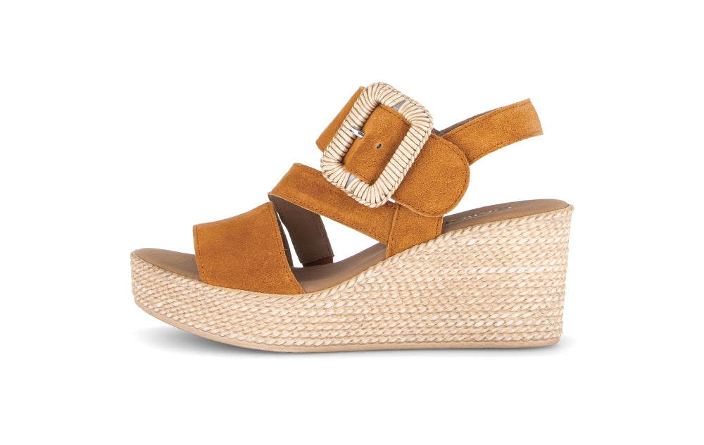 Brown wedge sandal with a woven sole on a white background