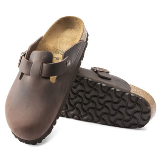 Brown clog shoe with cork sole on a white background