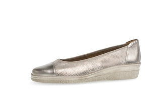 Gold wedge shoe on a white background