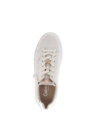 White sneaker with gold accents on a white background