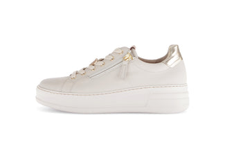 White sneaker with gold accents on a white background