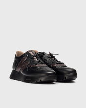 Load image into Gallery viewer, Black leather sneakers on a light gray background
