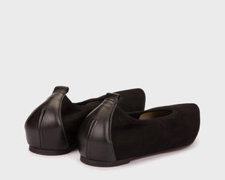 Black flat shoe on a white background