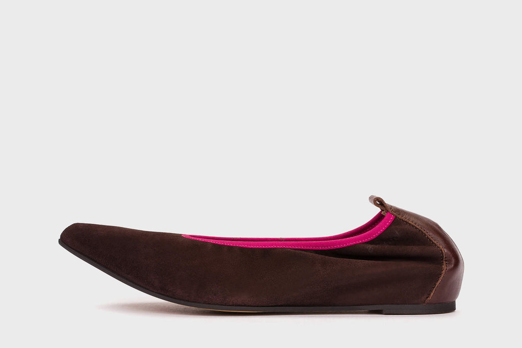 Brown flat shoe with pink interior on a white background
