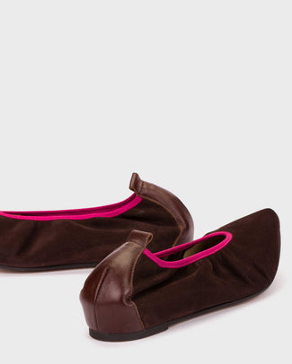 Brown flat shoe with pink interior on a white background