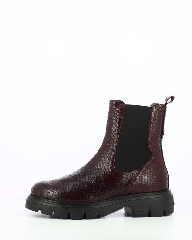 A single dark burgundy snakeskin-textured Chelsea boot with a black elastic side panel and a chunky black lug sole, shown from a side profile on a white background.