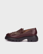 Load image into Gallery viewer, A single dark burgundy leather loafer with a chunky black lug sole and metallic studs on the strap, shown from a side profile against a light gray background.
