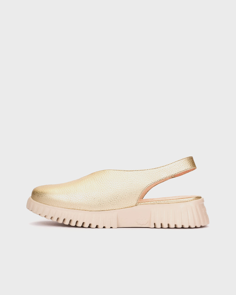 GOLD sandal with a thick sole on a light gray background