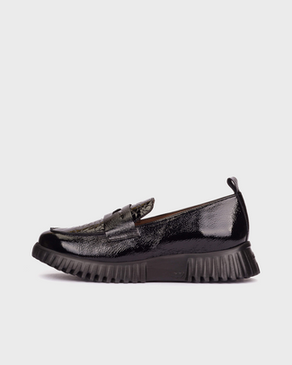 Black slip-on sneaker on a white background
