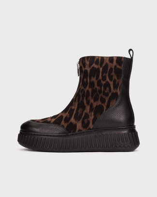 A platform ankle boot featuring a brown and black leopard print upper with solid black leather side panels, a black platform sole, and a side zipper.