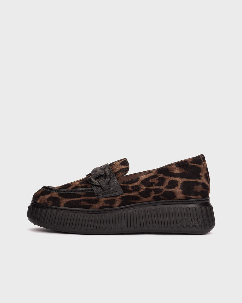 A single platform loafer in brown and black leopard print suede with a black strap and buckle detail, shown from a side profile on a light gray background.