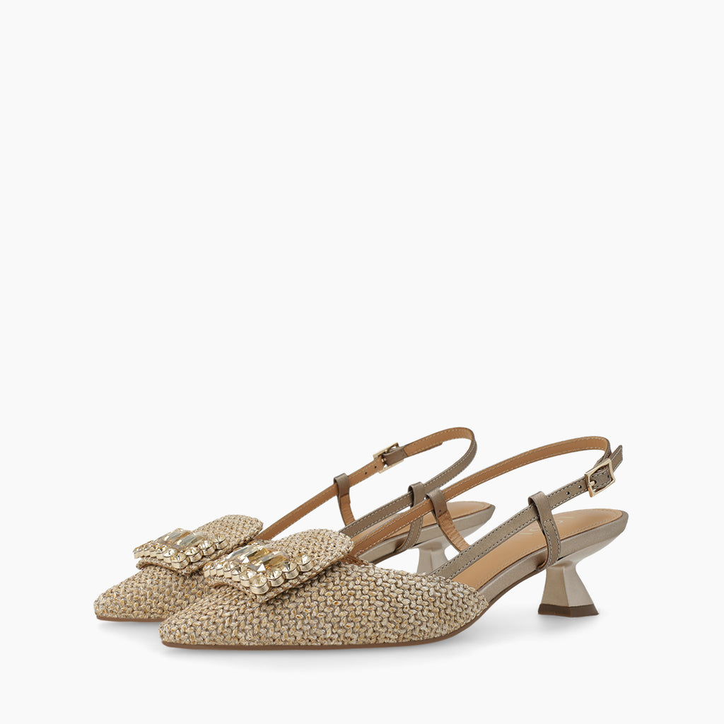 Pair of beige raffia slingback shoes with bow detail on a white background