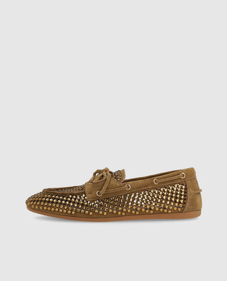 Brown suede loafer with studded details on a light gray background
