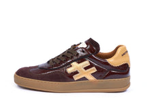 Load image into Gallery viewer, A low-top sneaker in dark brown leather with a tan cross logo on the side, a tan heel tab, and a tan gum sole, shown against a plain white background.

