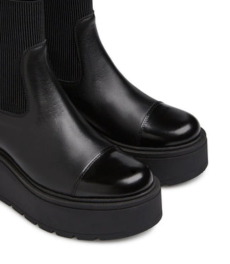 Black platform Chelsea boot on a white background